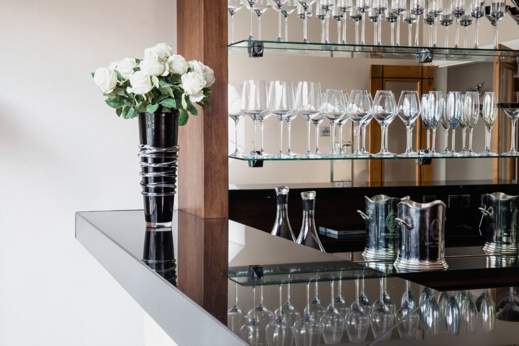 A bar with glasses and stone work
