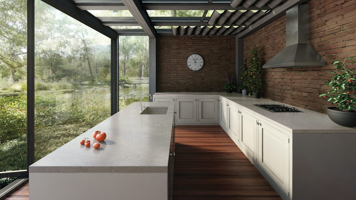 A rustic style kitchen with quartz top worktops, timber floors and brick walls
