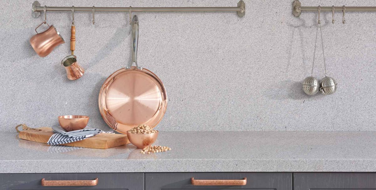 Grey granite kitchen worktop with copper kitchen accessories