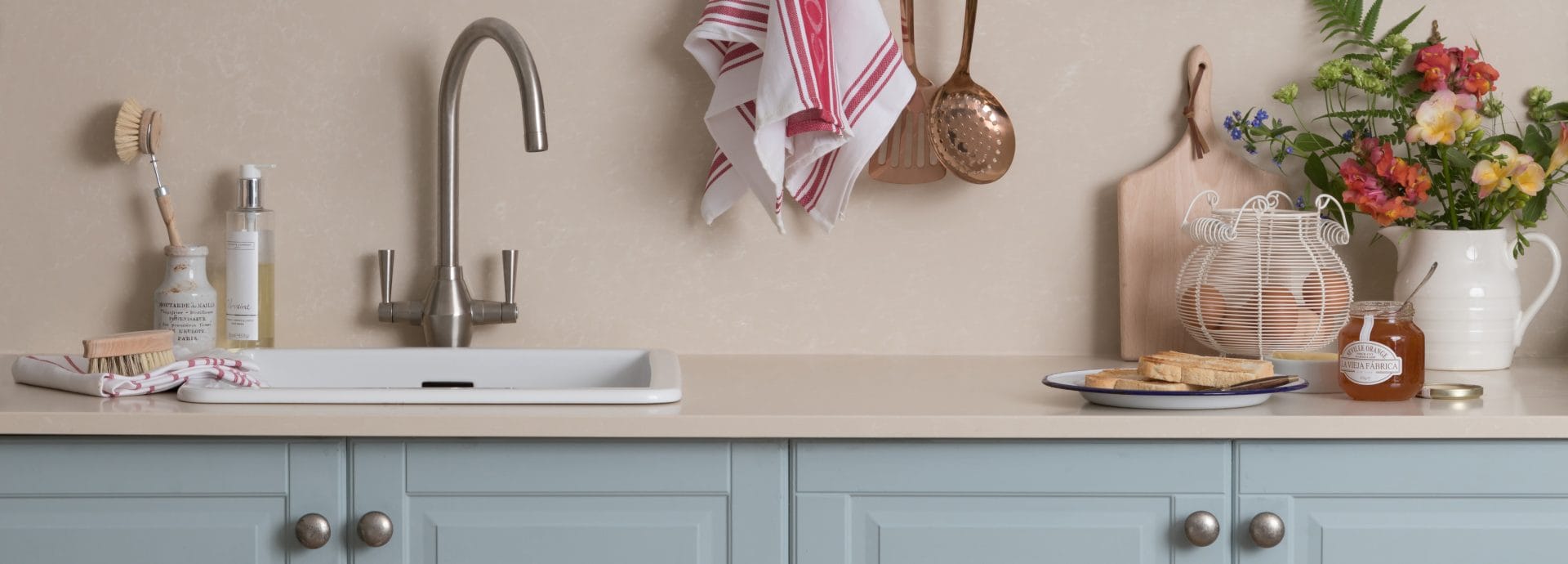 A country style kitchen with stone worktops and country decor