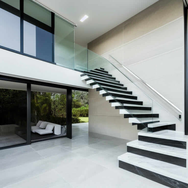 A minimalistic home room with marble stairs