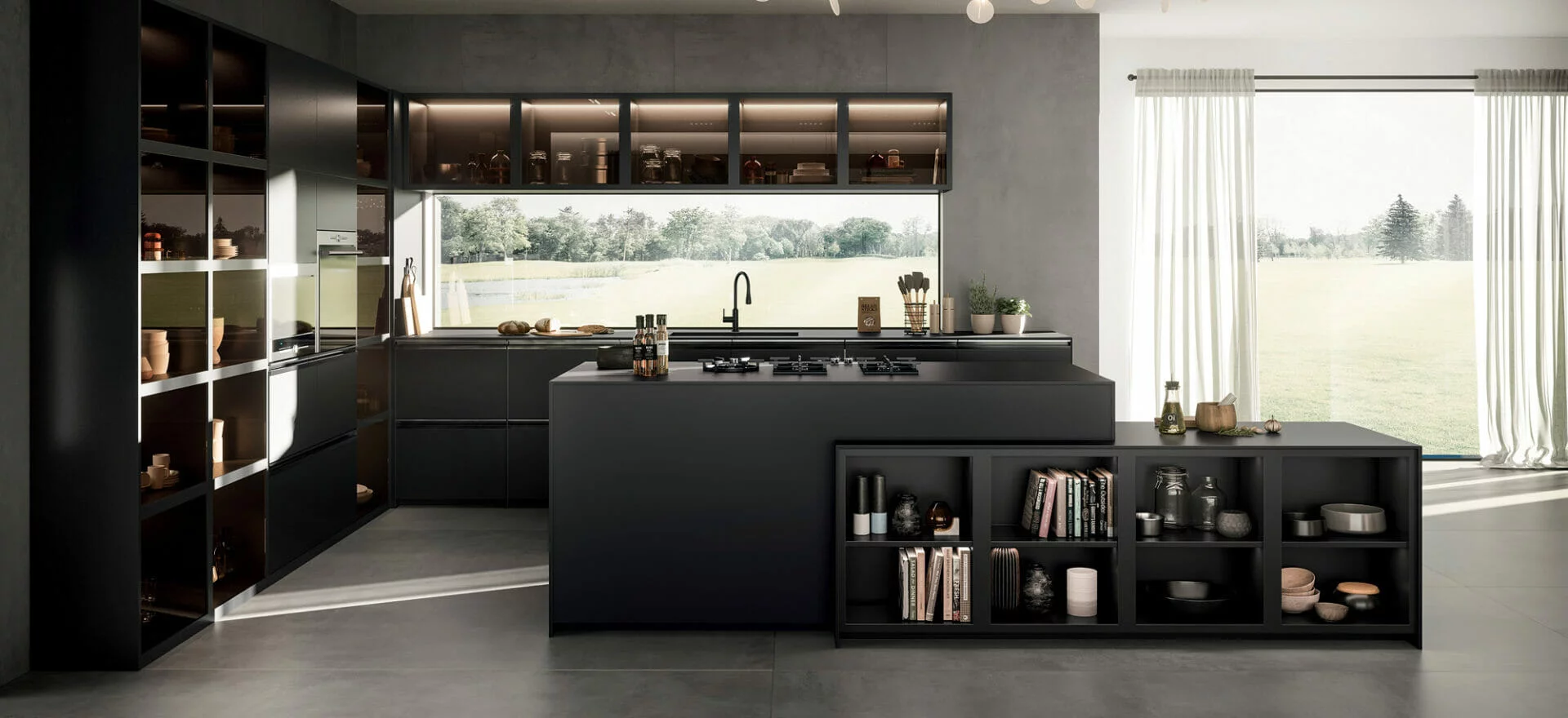 A contemporary kitchen in a dark grey colour scheme with large porcelain worktops with built in shelf space and cabinets
