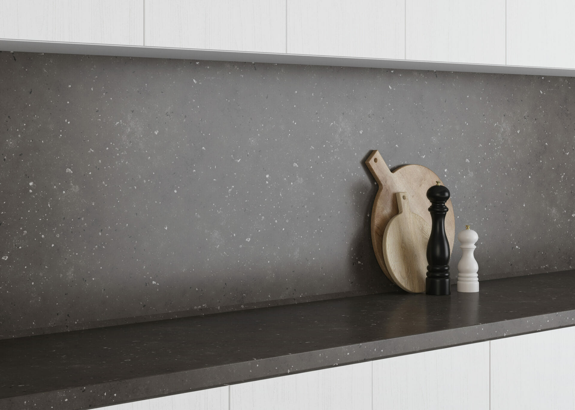 A grey kitchen worktop and granite splashbacks with kitchen accessories decor