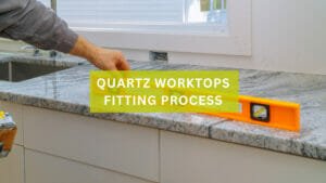 A kitchen worktop with a spirit level with text overlay saying 'quartz worktops fitting process'