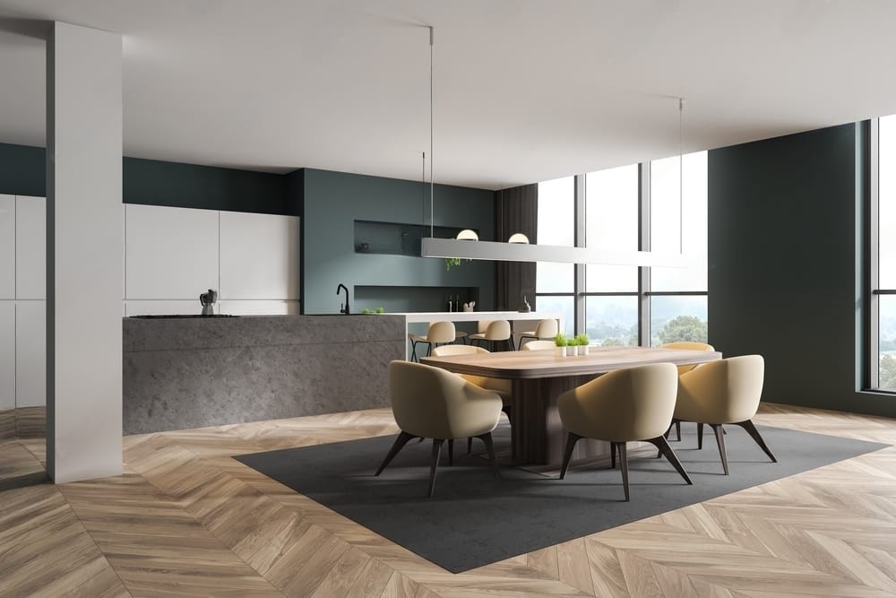 A modern room with a travertine dining table and chairs.