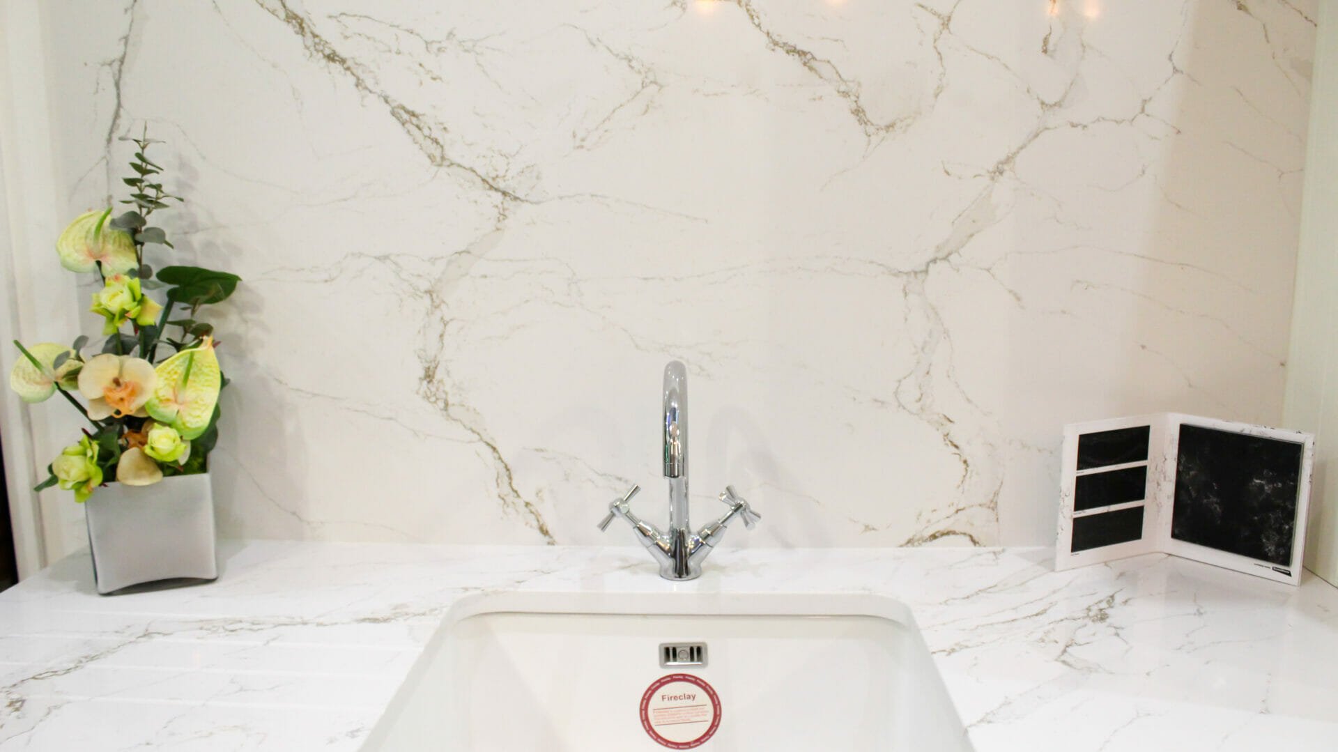 A quartz worktop and spashback with flower decor and stone samples