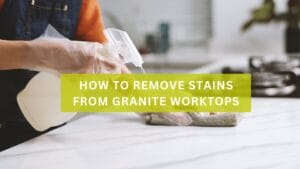 A person removing a stain from a granite worktop
