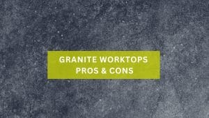 A dark grey granite worktop with text 'Granite Worktops Pros & Cons'